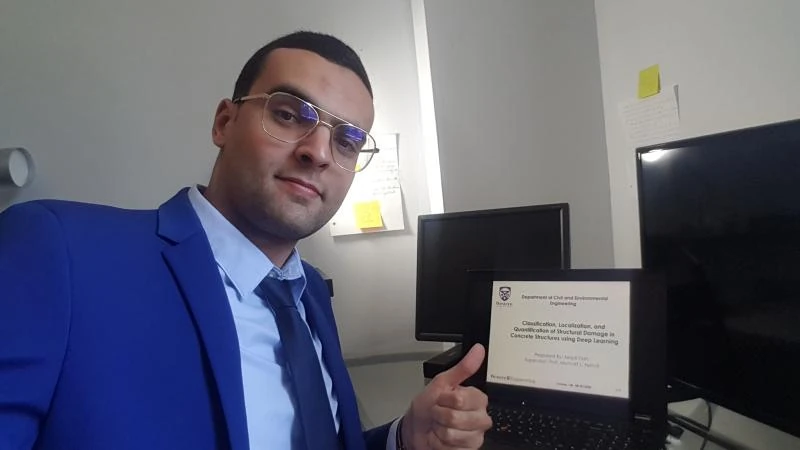 Majdi Flah after his 2020 master’s defence at Western University, beside a laptop showing his thesis title